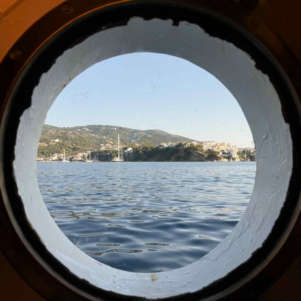 Porthole looking out over Skiathos, Greece