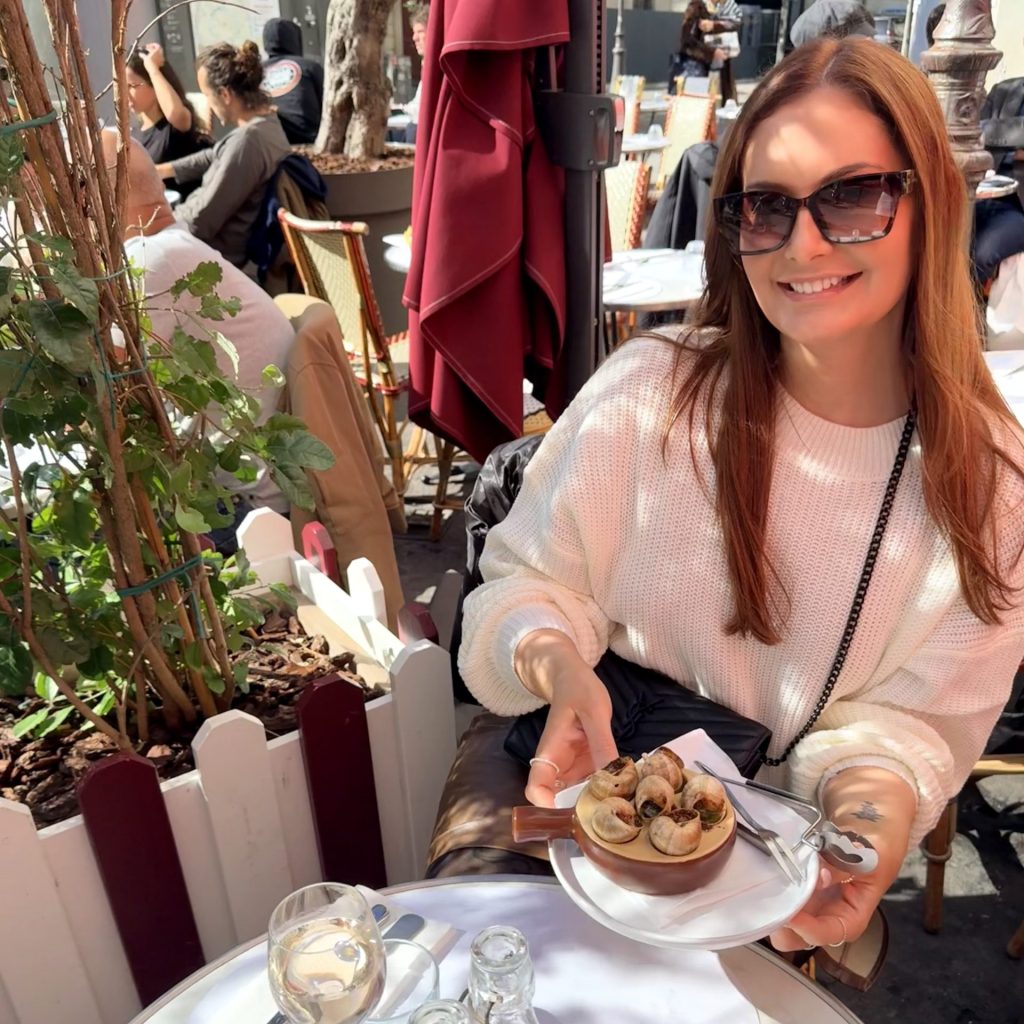 Alana embracing the Parisian way of life - escargot, a glass of rosé, and slowing down to savour the moment
